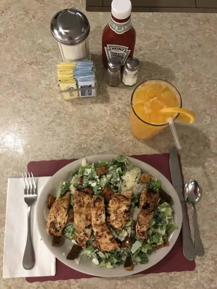 Grilled chicken Caesar salad with fresh orange juice