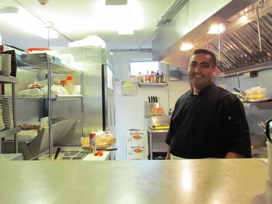 Cook smiling in the Old Town Cafe kitchen